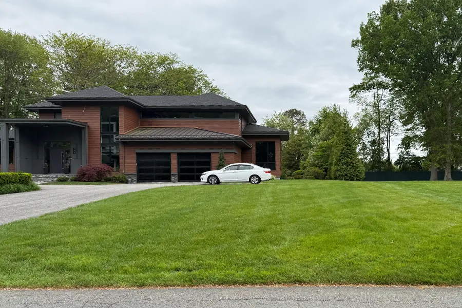 Two-story home with vibrant green lawn