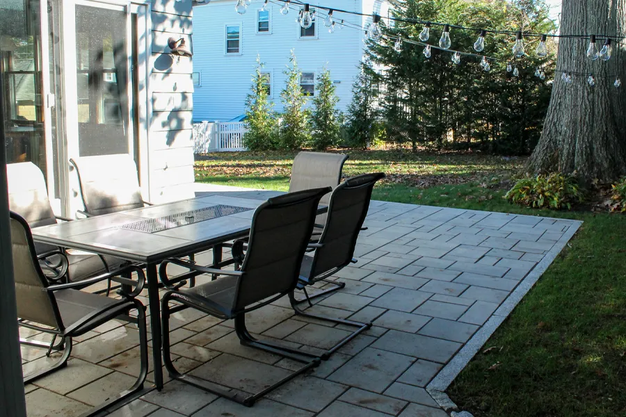 A patio area features a large, rectangular dining table